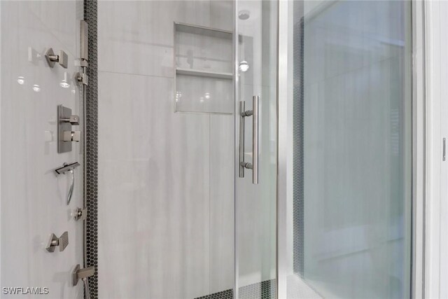 bathroom featuring a shower with shower door