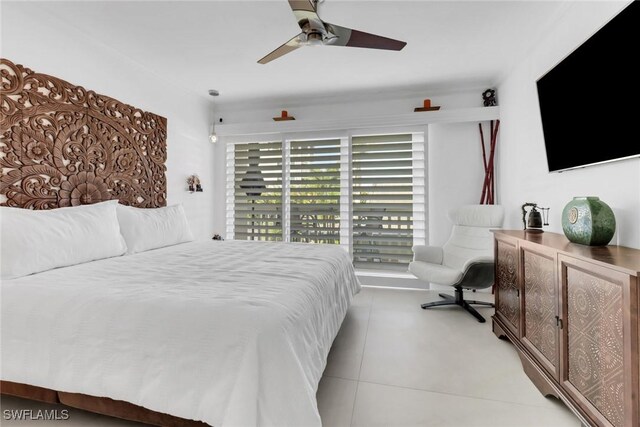 tiled bedroom featuring ceiling fan