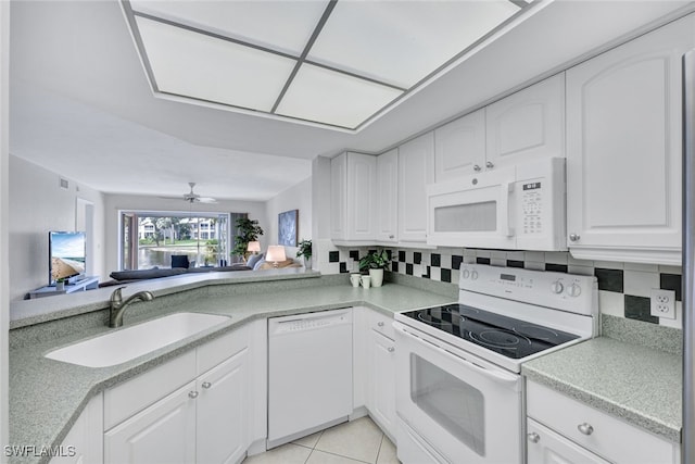 kitchen featuring sink, white cabinetry, light tile patterned floors, white appliances, and decorative backsplash