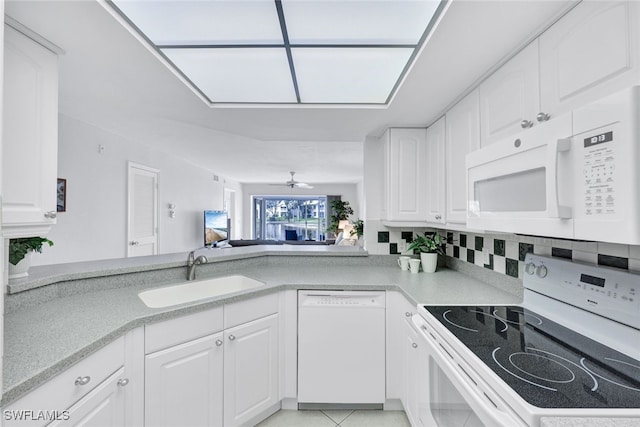 kitchen with white cabinetry, white appliances, sink, and light tile patterned floors