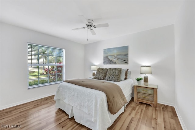 bedroom with ceiling fan and light wood-type flooring