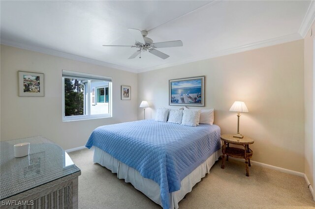 bedroom featuring ceiling fan, light colored carpet, and crown molding