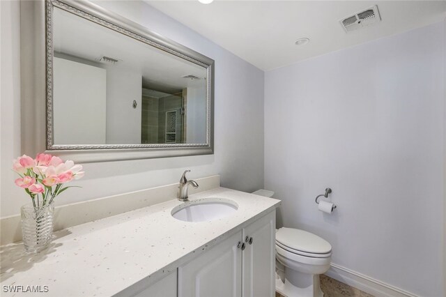 bathroom featuring toilet and vanity