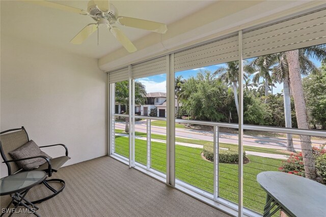 sunroom featuring ceiling fan