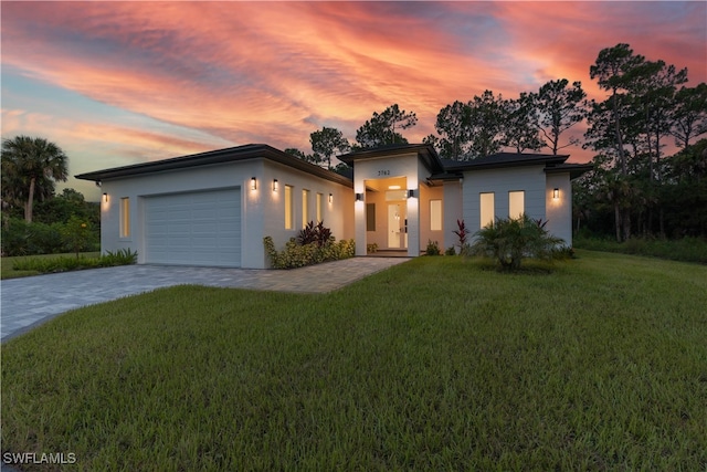 view of front of house with a yard and a garage