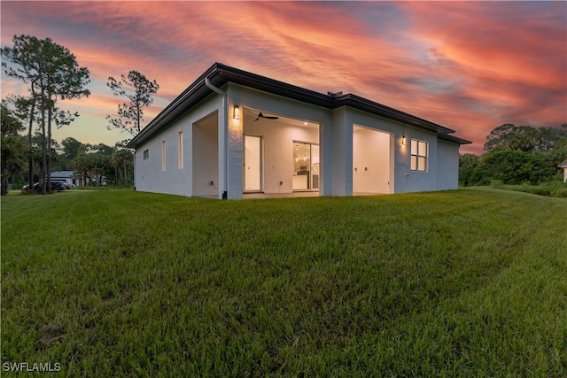 back house at dusk with a yard