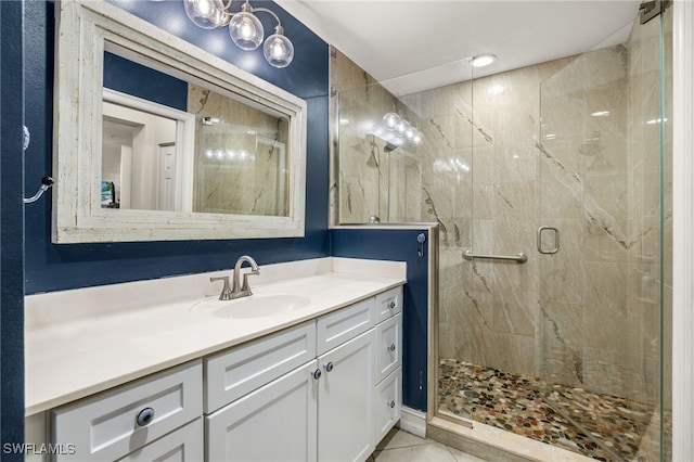 full bathroom featuring tile patterned flooring, a shower stall, and vanity