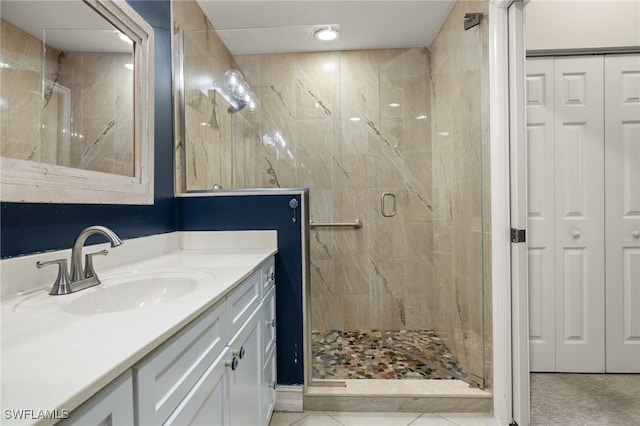 full bath with a closet, a shower stall, and vanity