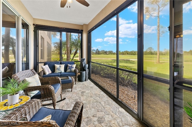 sunroom / solarium with a ceiling fan