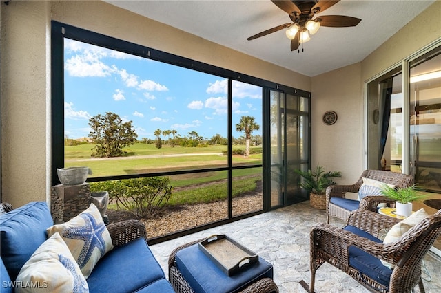 sunroom featuring a ceiling fan