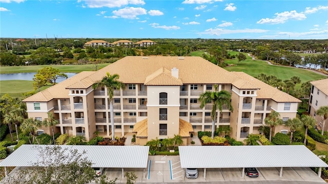 drone / aerial view featuring a water view and golf course view