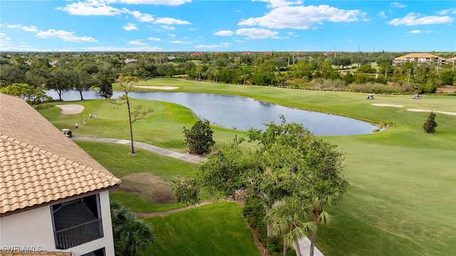 birds eye view of property with a water view and golf course view