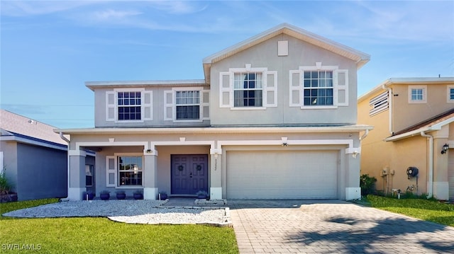 view of front facade with a garage and a front lawn