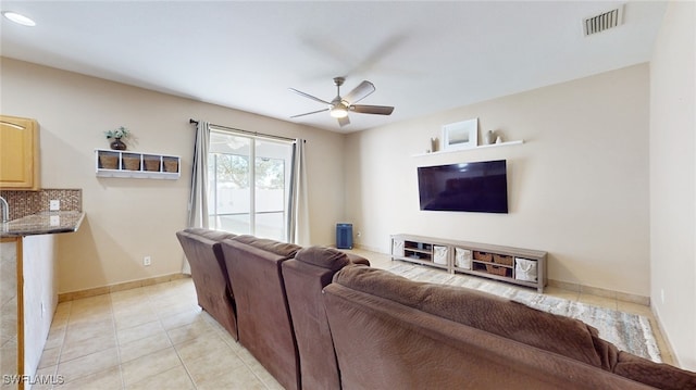 tiled living room featuring ceiling fan