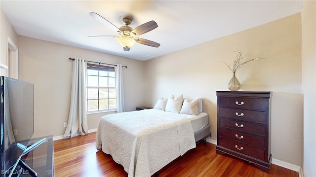 bedroom featuring ceiling fan and dark wood-type flooring