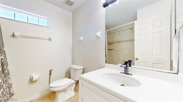 bathroom with toilet, vanity, tile patterned floors, and a shower with shower curtain