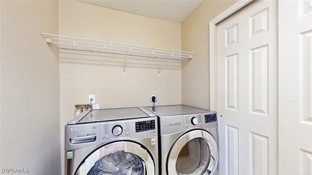 washroom with washing machine and dryer