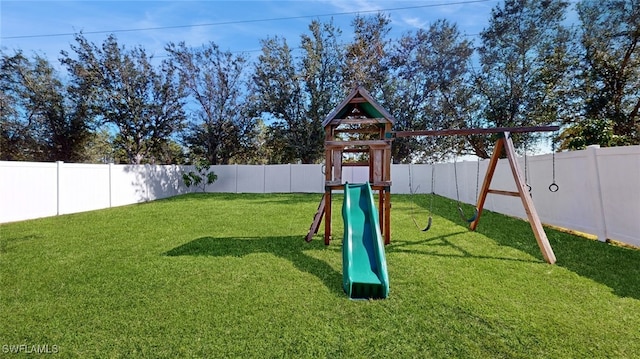 view of jungle gym featuring a lawn