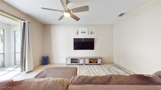 unfurnished living room with ceiling fan