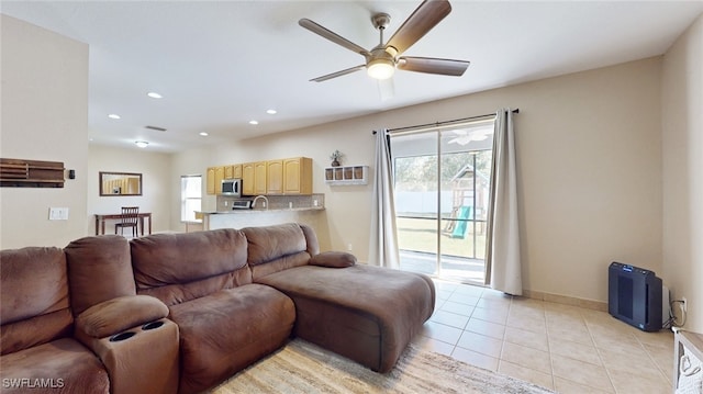 tiled living room featuring ceiling fan