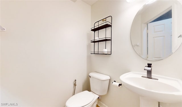 bathroom with toilet and sink