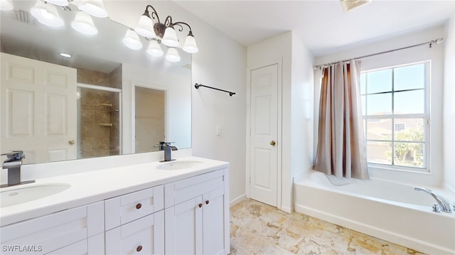 bathroom with vanity and shower with separate bathtub