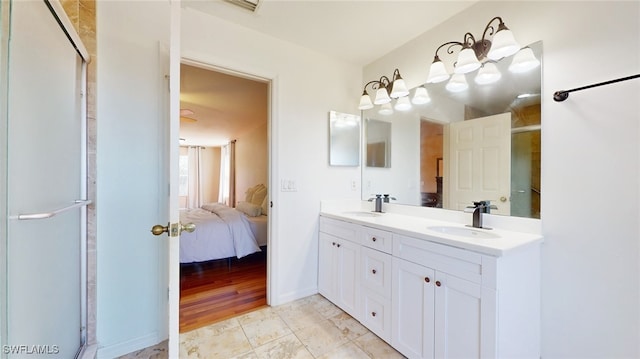 bathroom with vanity, a shower with shower door, and wood-type flooring