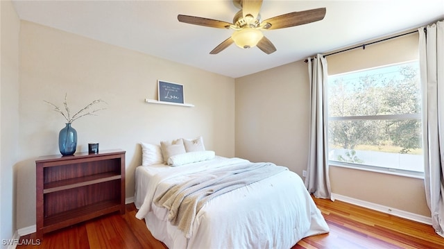 bedroom featuring wood-type flooring and ceiling fan