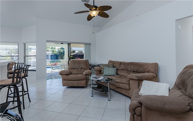 tiled living room featuring ceiling fan, plenty of natural light, and high vaulted ceiling