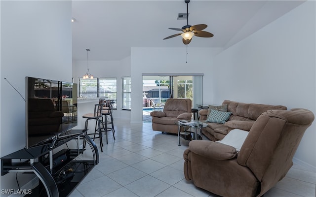 living room featuring light tile patterned floors, high vaulted ceiling, and ceiling fan with notable chandelier