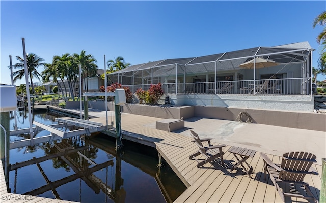 dock area with a water view and a lanai