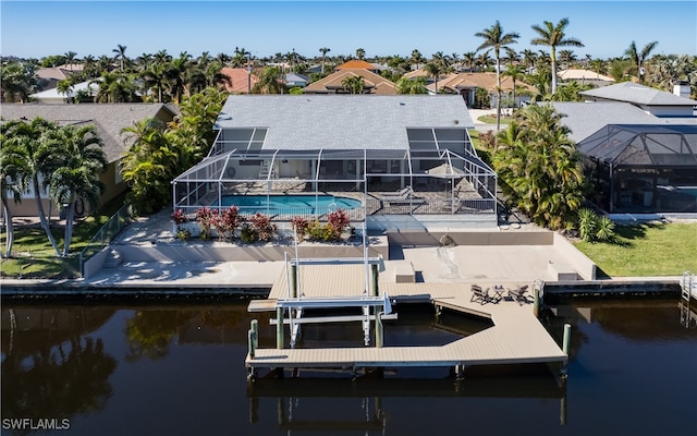 view of dock featuring glass enclosure and a water view