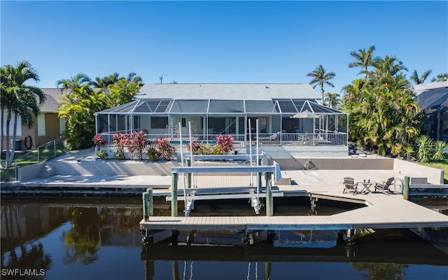 view of dock featuring glass enclosure and a water view