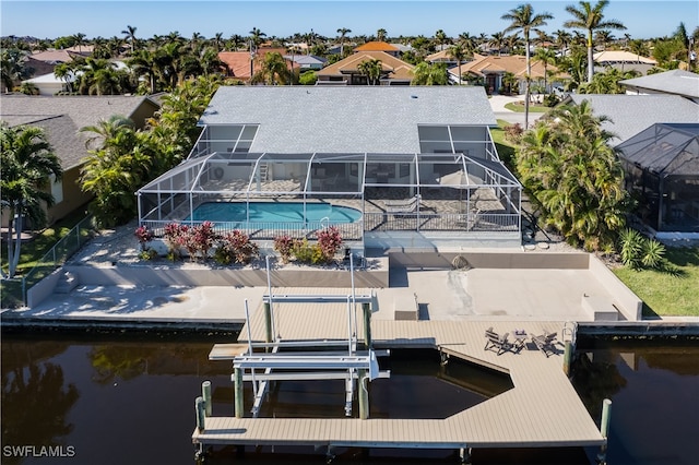 dock area featuring a water view and glass enclosure