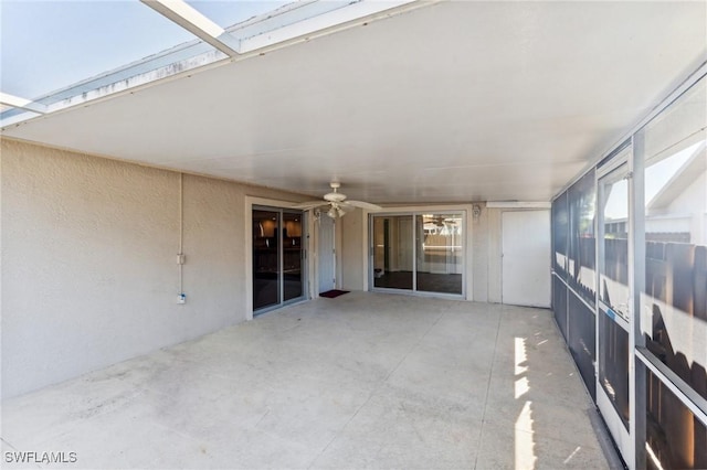 unfurnished sunroom with a skylight and a ceiling fan