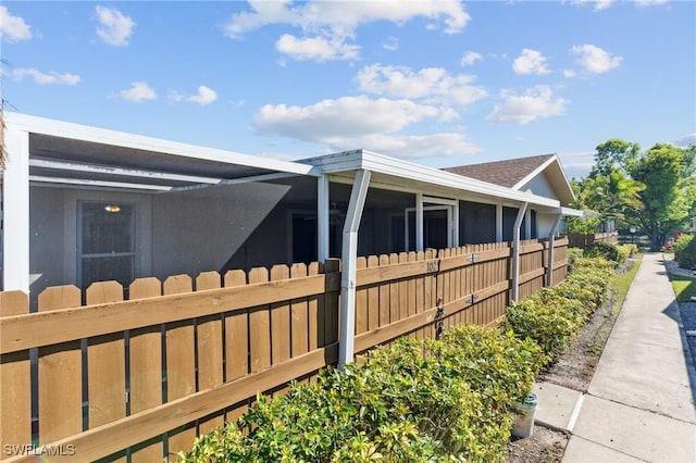 view of side of home with a fenced front yard