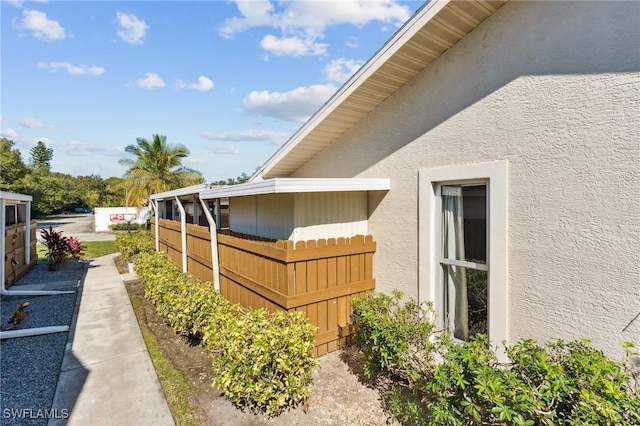 view of home's exterior featuring fence and stucco siding