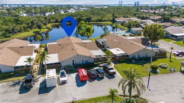 birds eye view of property with a water view and a residential view