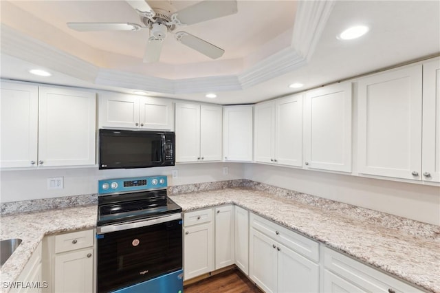 kitchen with black microwave, white cabinetry, electric stove, a tray ceiling, and crown molding