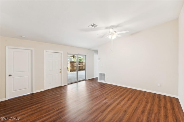 spare room featuring visible vents, dark wood finished floors, and baseboards