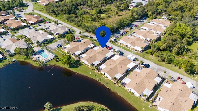 bird's eye view featuring a water view and a residential view