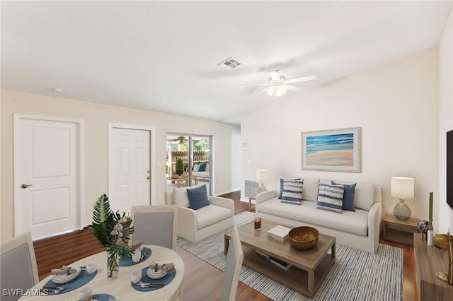 living area with visible vents, ceiling fan, and wood finished floors