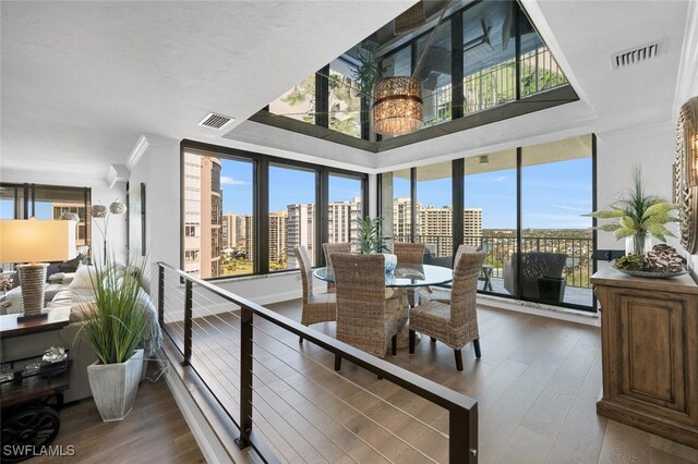 dining space with dark hardwood / wood-style floors and crown molding