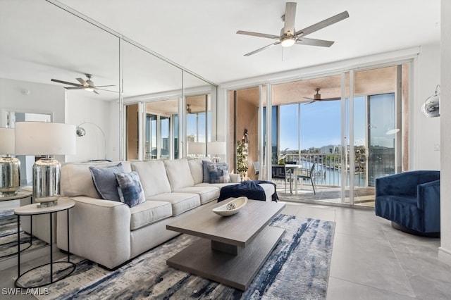 living room featuring a wall of windows, a water view, and a wealth of natural light