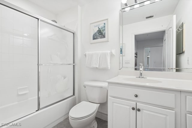 full bathroom featuring combined bath / shower with glass door, vanity, and toilet