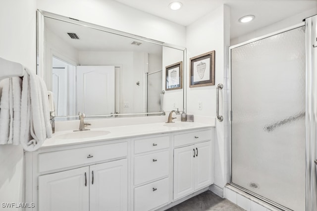 bathroom with vanity and a shower with shower door