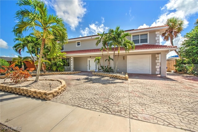 mediterranean / spanish-style home featuring a garage