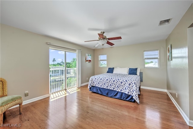 bedroom featuring hardwood / wood-style floors, ceiling fan, and access to exterior