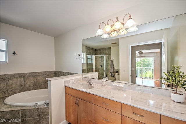 bathroom featuring vanity, plus walk in shower, and a chandelier