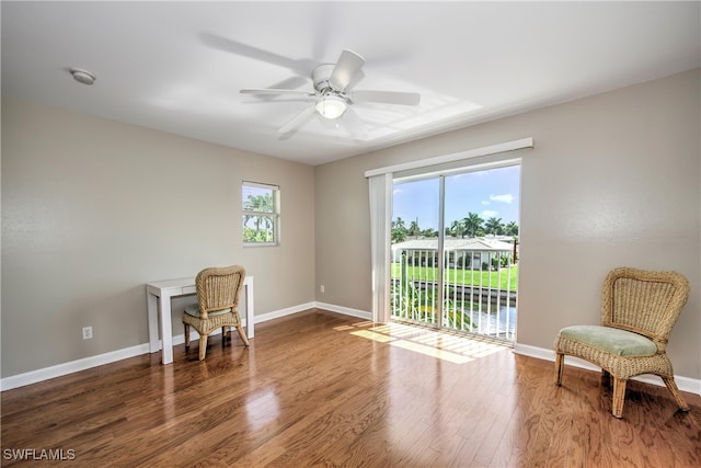 sitting room featuring ceiling fan and dark wood-type flooring